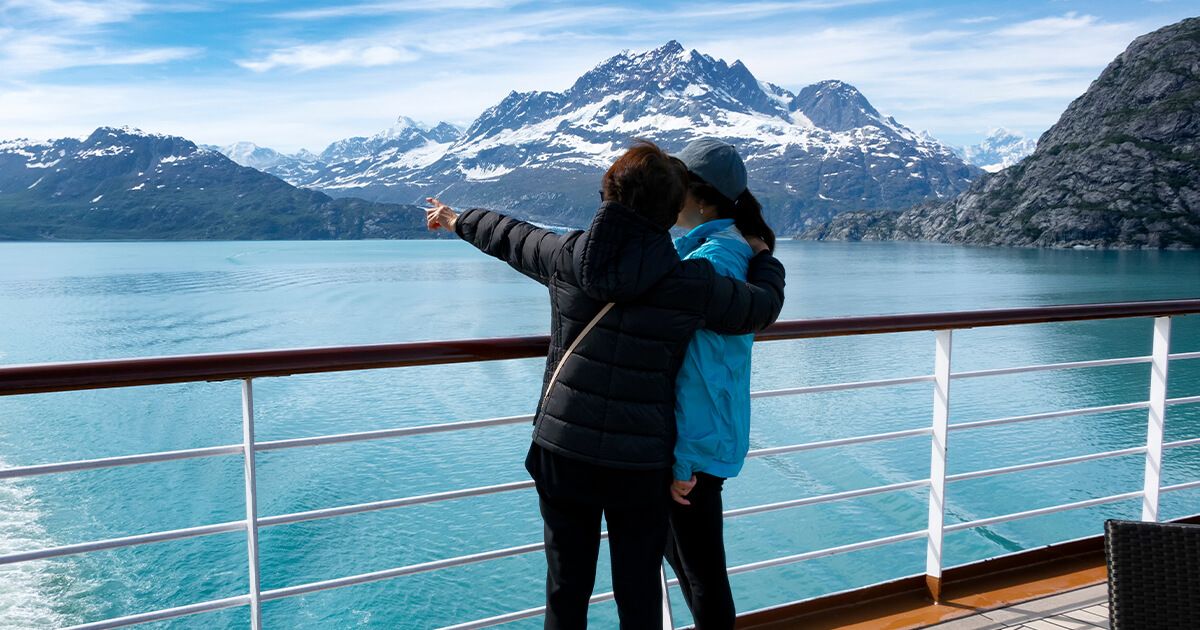Two people sight seeing on an Alaskan cruise.